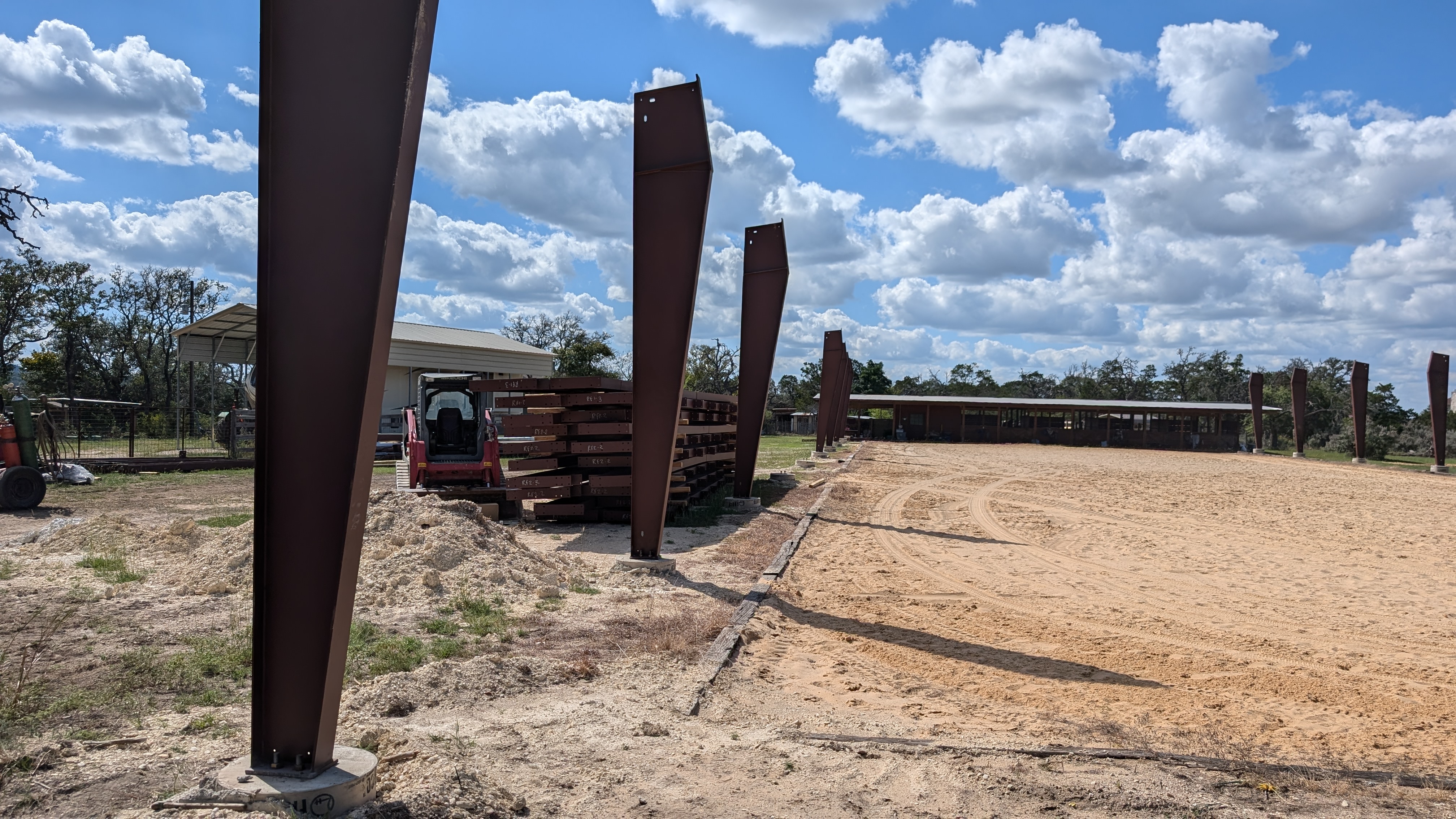 Horse arena construction with steel columns and riding surface in Boerne, Texas