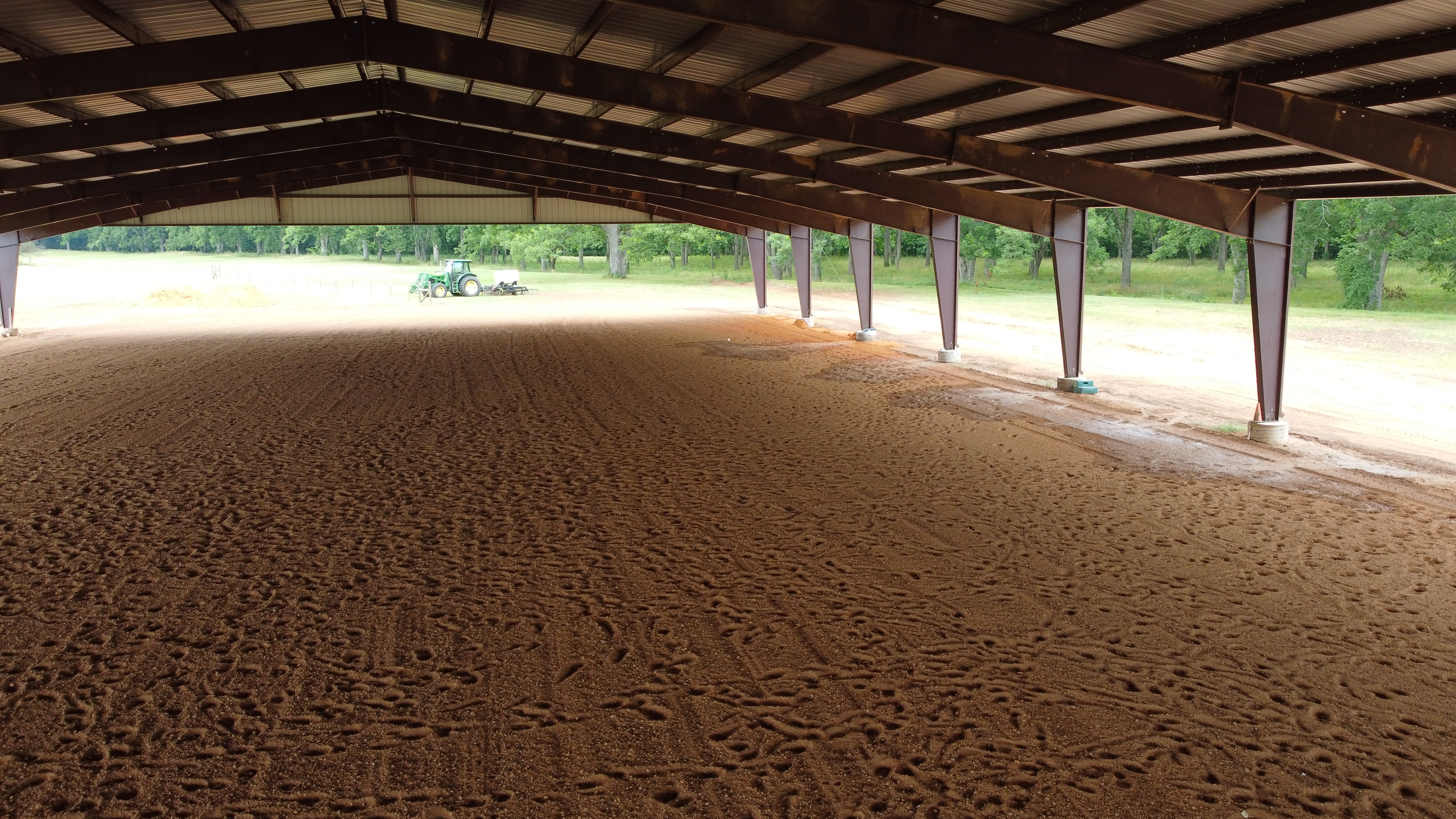 Covered horse arena with riding surface in Texarkana, Texas